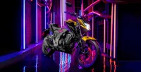 Moto Honda CB 300F Twister na cor Dourado Metálico Estacionada Em Rua Estreita Com Fundo Iluminado e Colorido 25