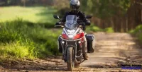 Homem Pilotando Moto Honda NC 750X em Estrada de Terra com Mato em Volta 29