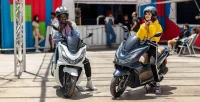 Mulher E Homem Vestindo Capacete Para Pilotar As Motos Honda PCX Nas Cores Azul e Branca 19
